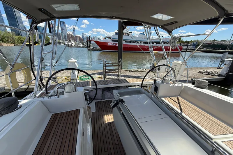 Slide: The Image of 2013 Beneteau Oceanis 41 sailboat docked at marina with city skyline view. - 45