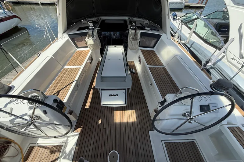 Slide: The Image of Cockpit of 2013 Beneteau Oceanis 41 sailboat with dual steering wheels and teak flooring. - 46