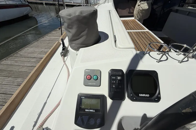 Slide: The Image of Control panel on a 2013 Beneteau Oceanis 41 sailboat, featuring Simrad and Maxwell equipment. - 48
