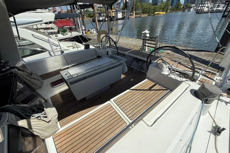 Slide: The Image of 2013 Beneteau Oceanis 41 sailboat cockpit with dual steering wheels, docked at marina. - 52