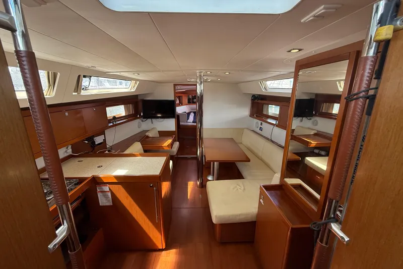 Slide: The Image of Interior of 2013 Beneteau Oceanis 41 yacht with modern wood finish and seating area. - 55