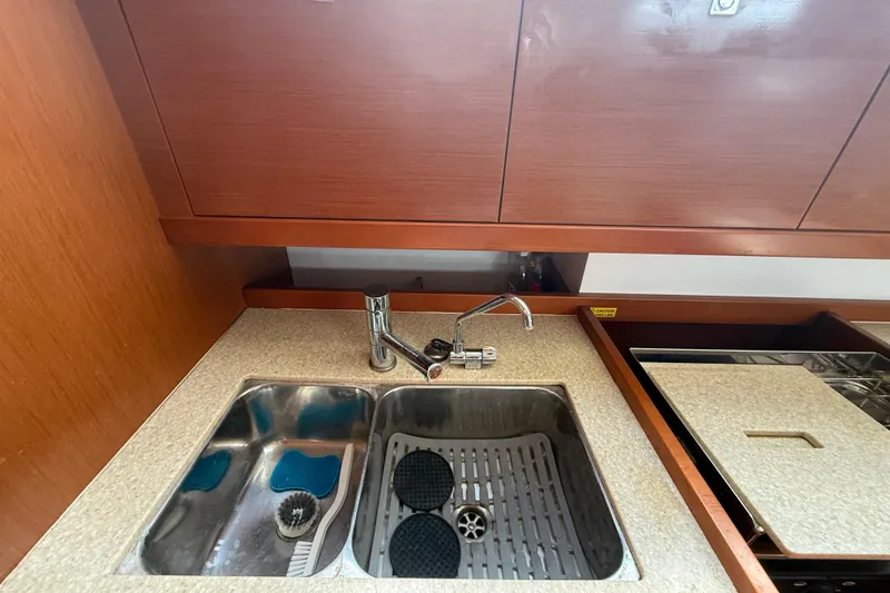 Slide: The Image of Galley sink area in 2013 Beneteau Oceanis 41 yacht with wooden cabinetry. - 59