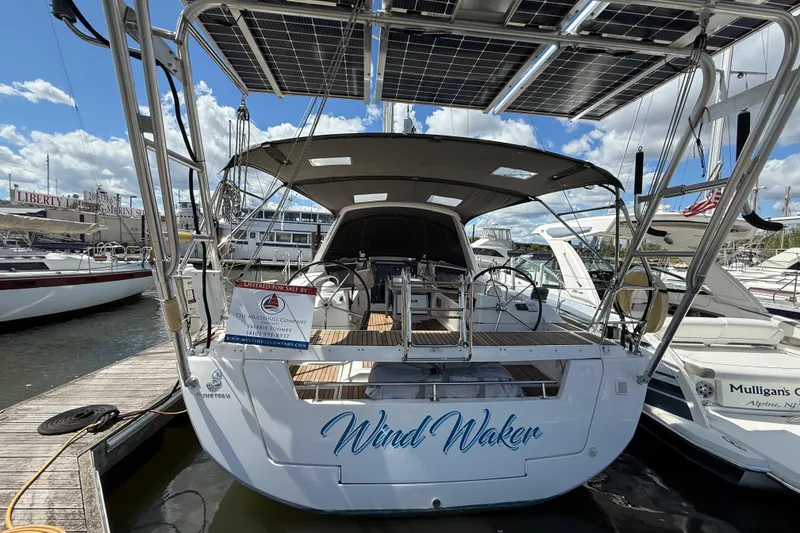 Slide: The Image of Beneteau Oceanis 41 sailboat, 2013 model, docked with solar panels and "Wind Waker" name. - 6