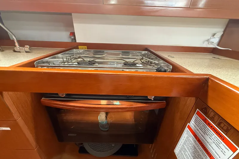 Slide: The Image of Galley kitchen in 2013 Beneteau Oceanis 41 sailboat with stove and oven. - 60
