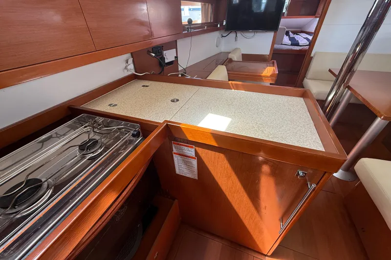 Slide: The Image of Interior of 2013 Beneteau Oceanis 41 yacht kitchen with stove and seating area. - 61