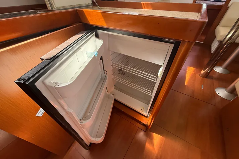 Slide: The Image of Open refrigerator in 2013 Beneteau Oceanis 41 yacht interior, wooden cabinetry. - 62