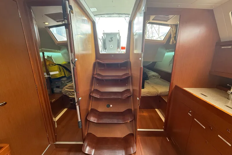 Slide: The Image of Interior of 2013 Beneteau Oceanis 41 sailboat with wooden stairs and cozy cabins. - 64