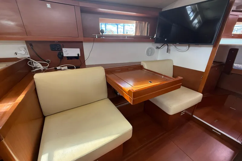 Slide: The Image of Interior of 2013 Beneteau Oceanis 41 yacht with seating, table, and mounted TV. - 67