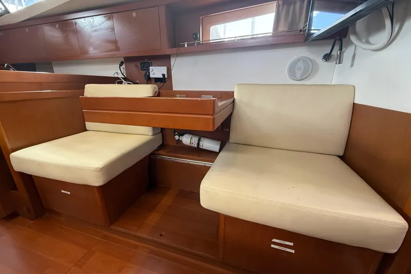 Slide: The Image of Interior of 2013 Beneteau Oceanis 41 yacht with beige seating and wooden finish. - 68