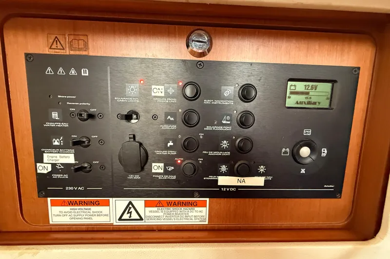 Slide: The Image of Control panel of a 2013 Beneteau Oceanis 41 sailboat, featuring various switches and indicators. - 72