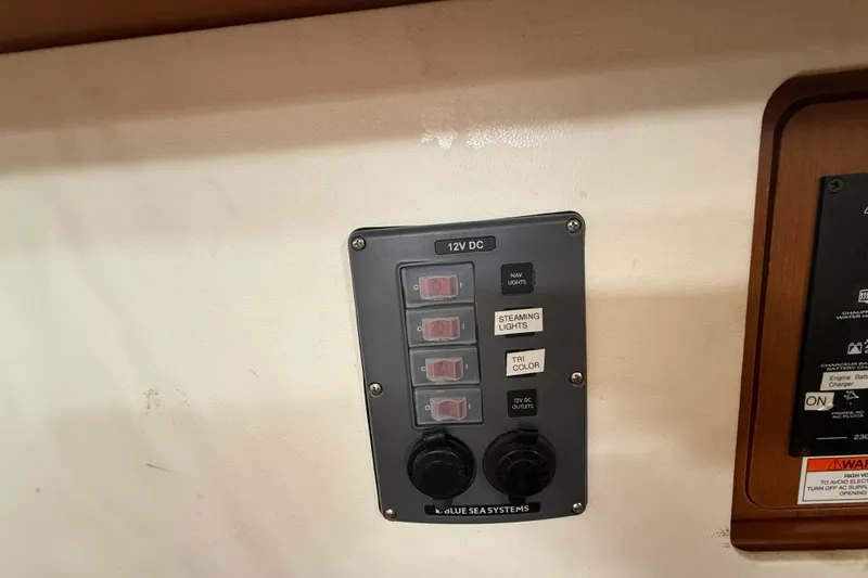 Slide: The Image of Control panel on a 2013 Beneteau Oceanis 41 sailboat, featuring 12V DC switches. - 73