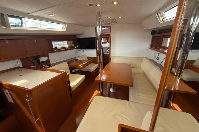 Slide: The Image of Interior of 2013 Beneteau Oceanis 41 yacht with modern seating and dining area. - 75