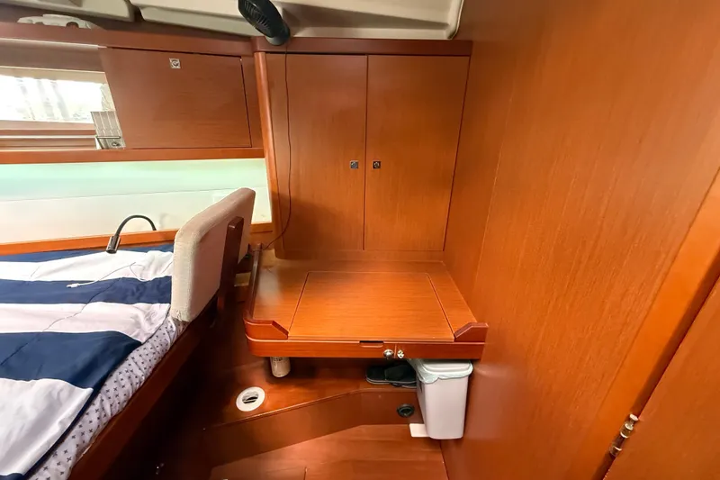 Slide: The Image of Interior cabin of 2013 Beneteau Oceanis 41 yacht with wooden cabinetry and bed. - 81