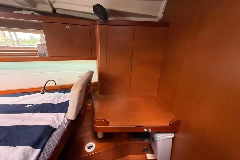Slide: The Image of Interior cabin of 2013 Beneteau Oceanis 41 yacht with wooden cabinetry and bed. - 83