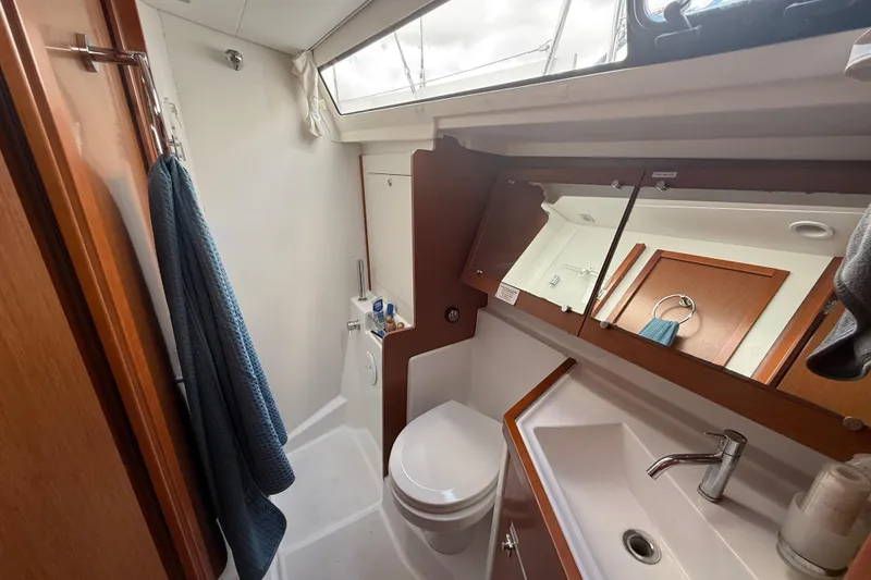 Slide: The Image of Bathroom interior of 2013 Beneteau Oceanis 41 yacht, featuring sink, toilet, and mirror. - 89
