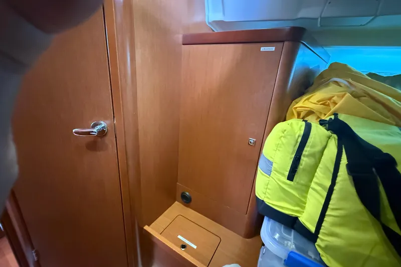 Slide: The Image of Interior of 2013 Beneteau Oceanis 41 sailboat with wooden cabinetry and storage area. - 94