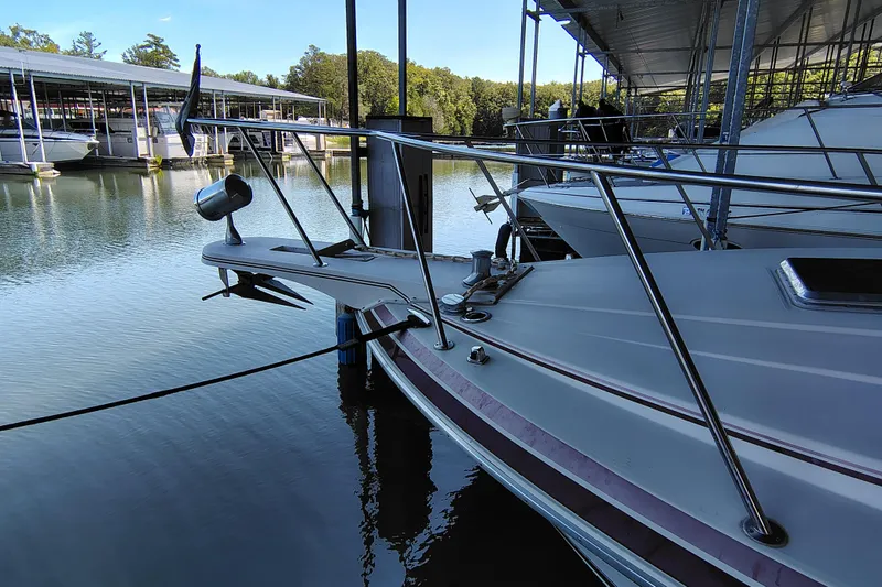 Slide: The Image of 1989 Wellcraft Gran Sport 3400 docked at a marina, surrounded by calm water. - 14
