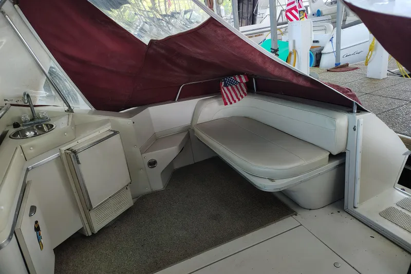 Slide: The Image of 1989 Wellcraft Gran Sport 3400 interior with seating, kitchenette, and American flag decor. - 17