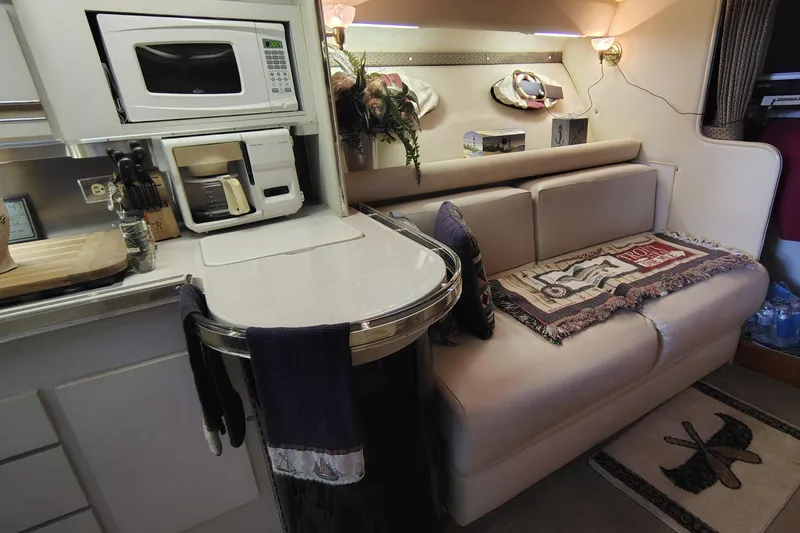 Slide: The Image of Interior of 1989 Wellcraft Gran Sport 3400 with kitchenette and cozy seating area. - 2