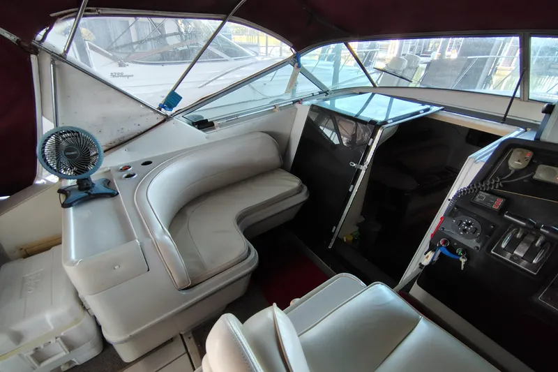 Slide: The Image of 1989 Wellcraft Gran Sport 3400 interior with seating, control panel, and fan. - 20