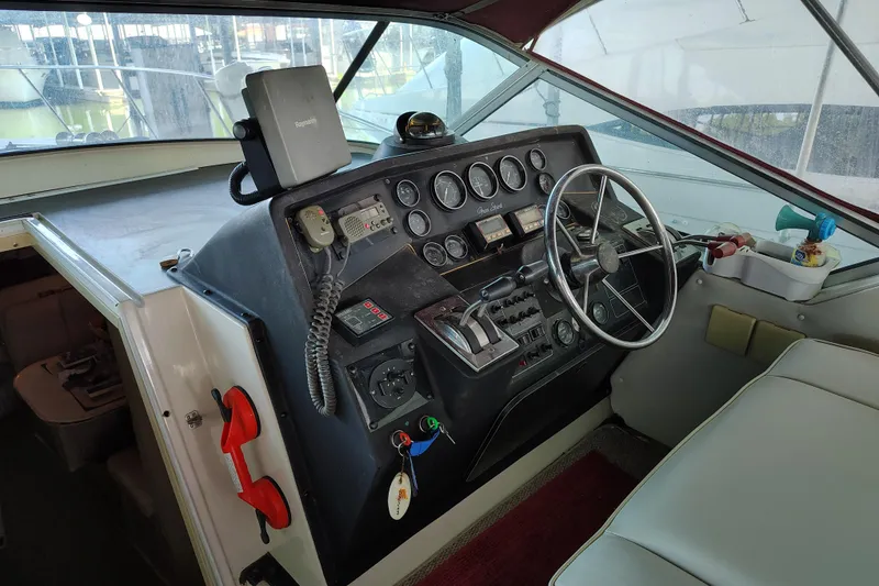 Slide: The Image of 1989 Wellcraft Gran Sport 3400 boat cockpit with steering wheel and control panel. - 23
