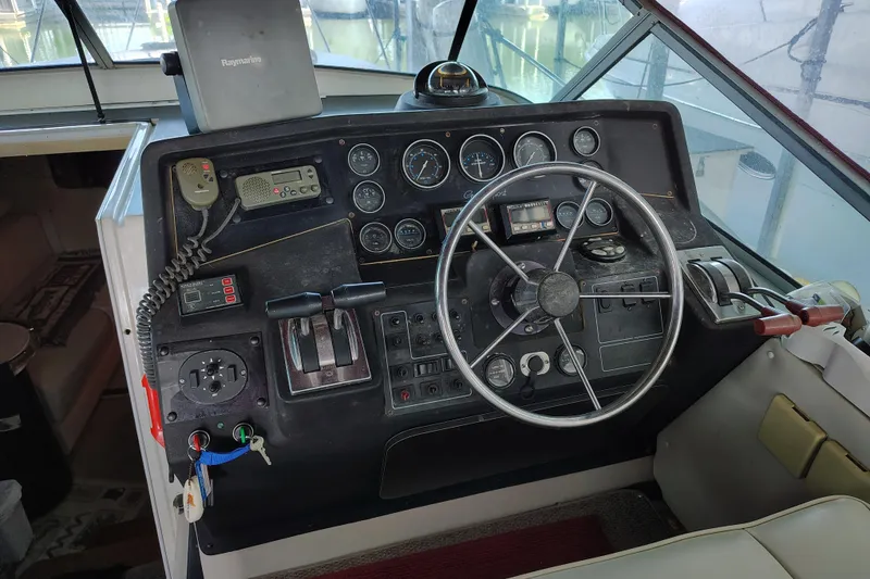 Slide: The Image of 1989 Wellcraft Gran Sport 3400 boat dashboard with steering wheel and control panel. - 25