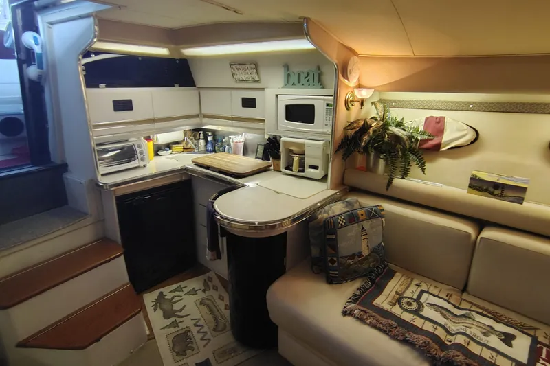 Slide: The Image of Interior of 1989 Wellcraft Gran Sport 3400 boat with cozy kitchen and seating area. - 26
