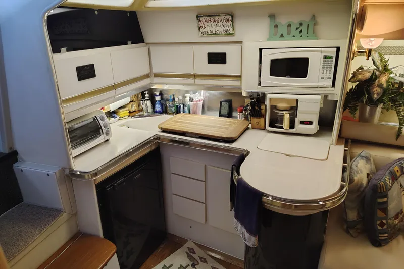 Slide: The Image of Wellcraft Gran Sport 3400 1989 boat kitchen with appliances and decor. - 27
