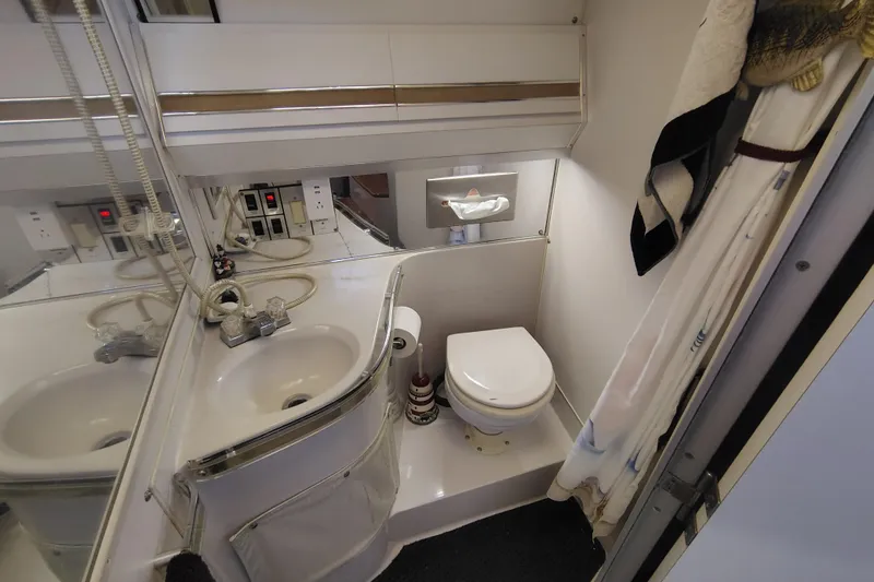 Slide: The Image of Bathroom interior of 1989 Wellcraft Gran Sport 3400 boat, featuring sink and toilet. - 30