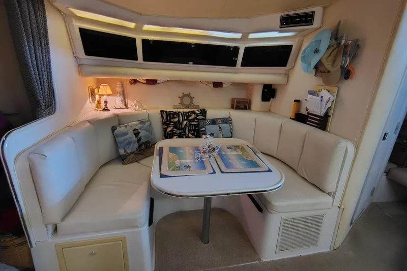 Slide: The Image of 1989 Wellcraft Gran Sport 3400 interior with cozy dining area and nautical decor. - 32
