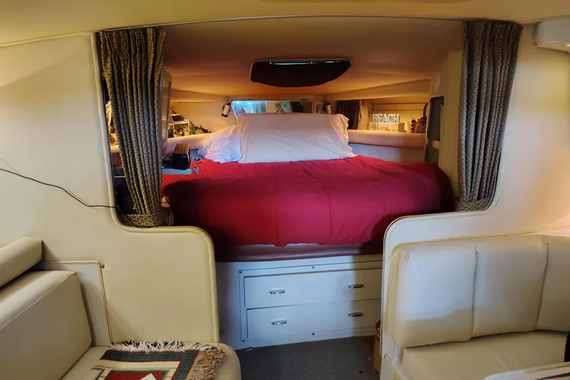 Slide: The Image of Interior of 1989 Wellcraft Gran Sport 3400 with cozy bed and elegant furnishings. - 34