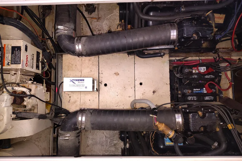 Slide: The Image of Engine compartment of a 1989 Wellcraft Gran Sport 3400 boat, featuring dual engines and batteries. - 39