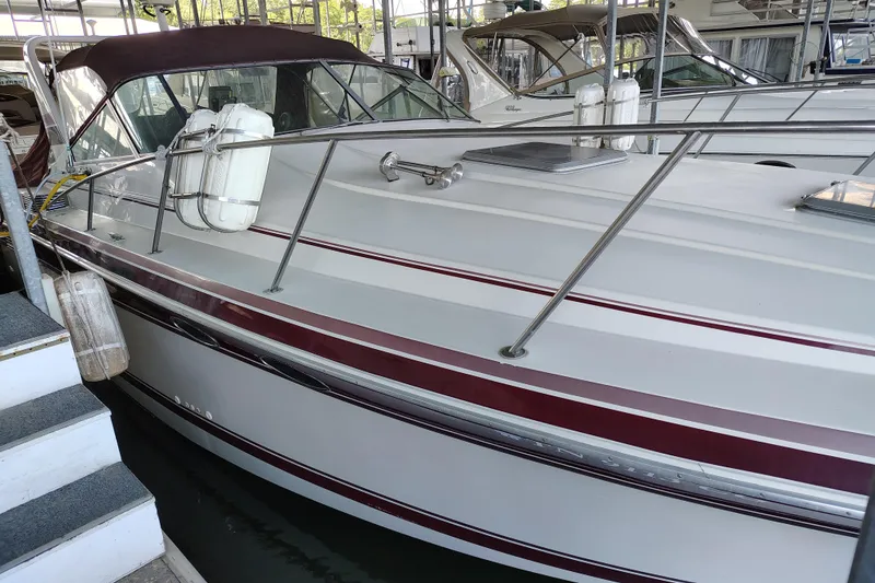 Slide: The Image of 1989 Wellcraft Gran Sport 3400 boat docked, featuring maroon and white exterior. - 4