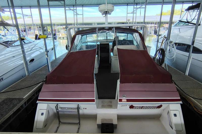 Slide: The Image of 1989 Wellcraft Gran Sport 3400 docked in a marina with burgundy covers. - 8