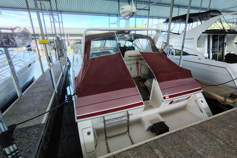 Slide: The Image of 1989 Wellcraft Gran Sport 3400 boat docked under a covered marina. - 9
