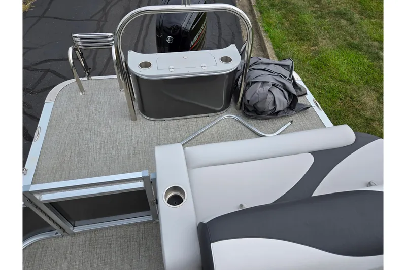 Slide: The Image of 2024 Avalon LSZ Cruise Bench boat deck with seating and motor, featuring modern design. - 15
