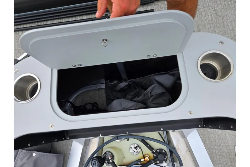 Slide: The Image of Open storage compartment on 2024 Avalon LSZ Cruise Bench with cup holders. - 16