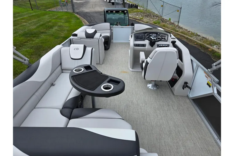 Slide: The Image of 2024 Avalon LSZ Cruise Bench pontoon boat interior with plush seating and modern helm. - 18
