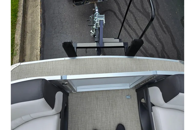 Slide: The Image of 2024 Avalon LSZ Cruise Bench boat interior with gray flooring and black seats. - 25