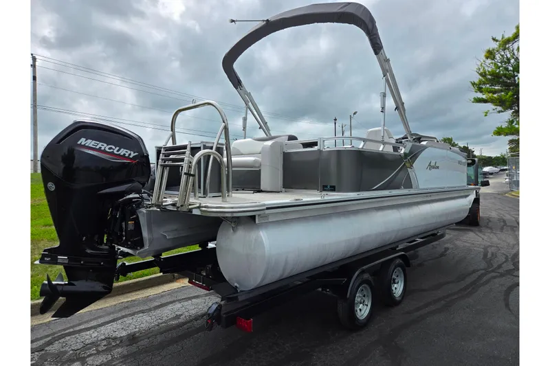 Slide: The Image of 2024 Avalon LSZ Cruise Bench pontoon boat with Mercury outboard motor on trailer. - 3