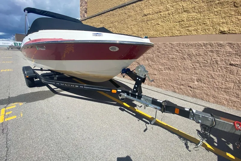 Slide: The Image of 2013 Bayliner 185 Bowrider boat on trailer, parked outdoors. - 3