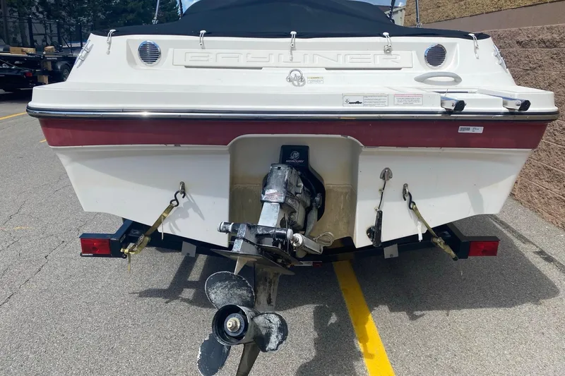 Slide: The Image of 2013 Bayliner 185 Bowrider boat rear view with outboard motor on trailer. - 4