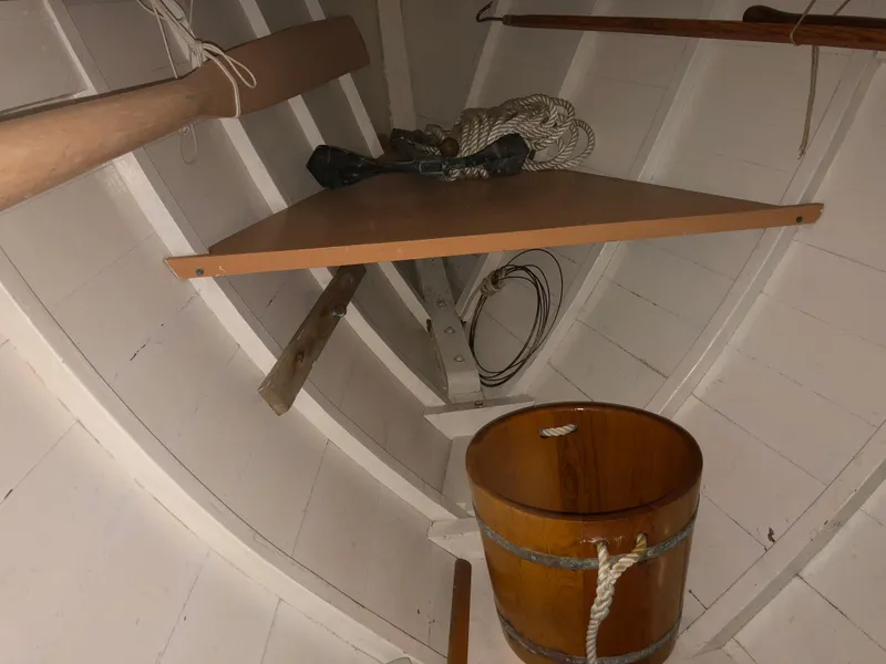 Slide: The Image of Interior of 1972 Herreshoff Rozinante sailboat with wooden bucket and ropes. - 12