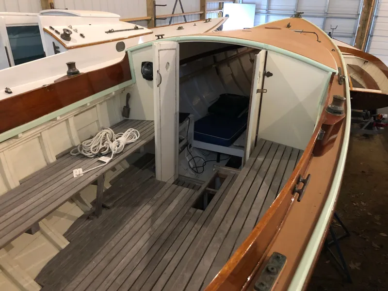 Slide: The Image of 1972 Herreshoff Rozinante sailboat interior with wooden deck and cabin. - 7