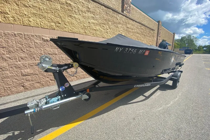 Slide: The Image of 2023 Crestliner 1650 Discovery SC boat on trailer, parked outdoors. - 0