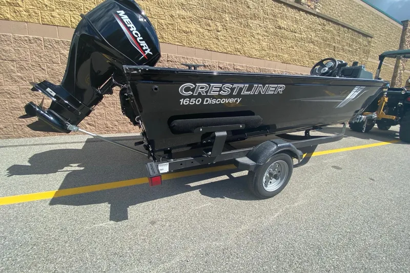 Slide: The Image of 2023 Crestliner 1650 Discovery SC boat with Mercury engine on trailer. - 2