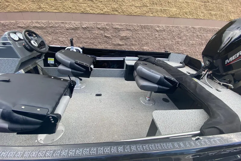 Slide: The Image of 2023 Crestliner 1650 Discovery SC boat interior with seating and steering console. - 6