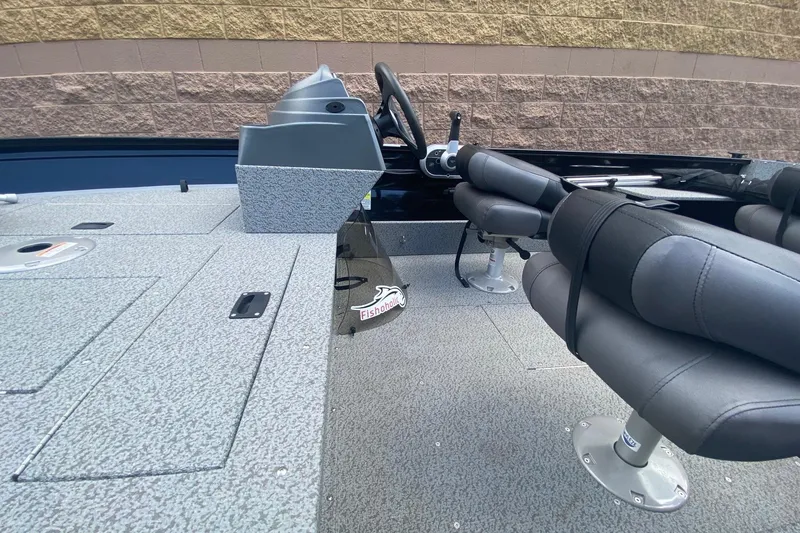 Slide: The Image of 2023 Crestliner 1650 Discovery SC interior with steering console and cushioned seats. - 8