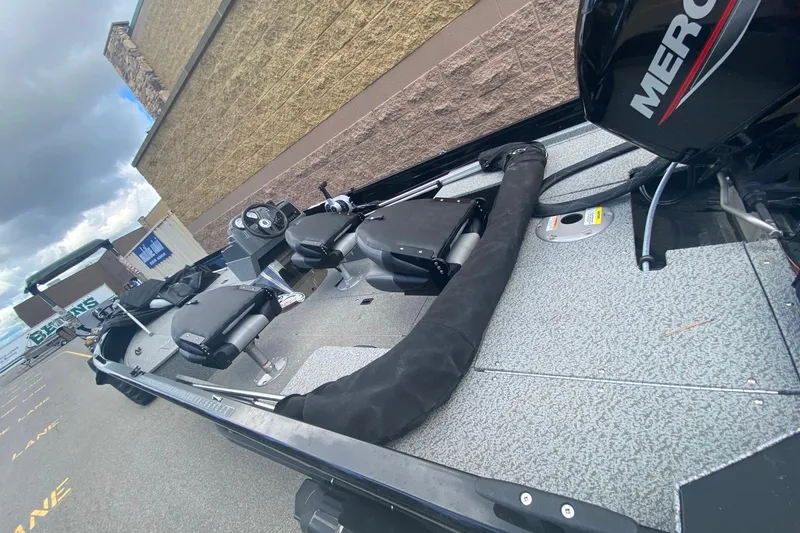 Slide: The Image of 2023 Crestliner 1650 Discovery SC boat with Mercury engine, parked outdoors. - 9