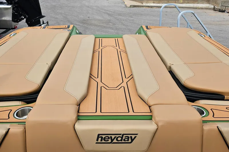 Slide: The Image of 2025 Heyday WTSurf boat with tan seating and stylish deck design. - 15